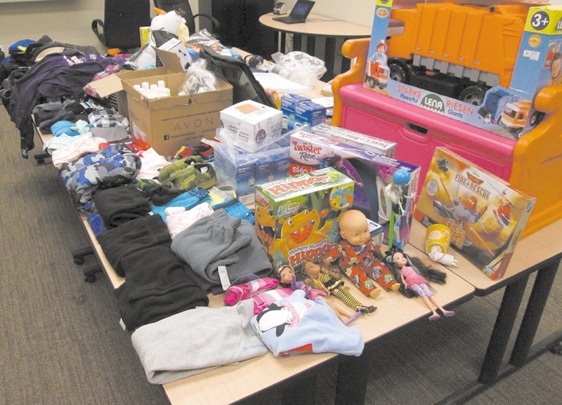 RCMP display some of the items recovered when a search warrant was executed on an Airdrie residence. Elia Rullan, 40, faces 12 charges after being accused of stealing boxes