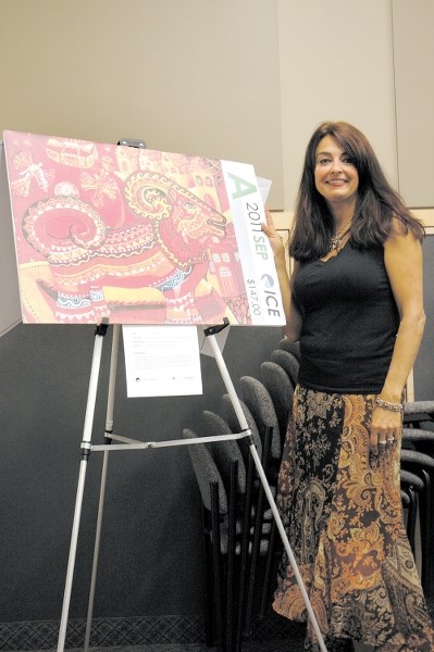 Artist Char Vanderhorst shows off the artwork she created that was choosen to be part of the Art in Motion program in its first year in 2011.