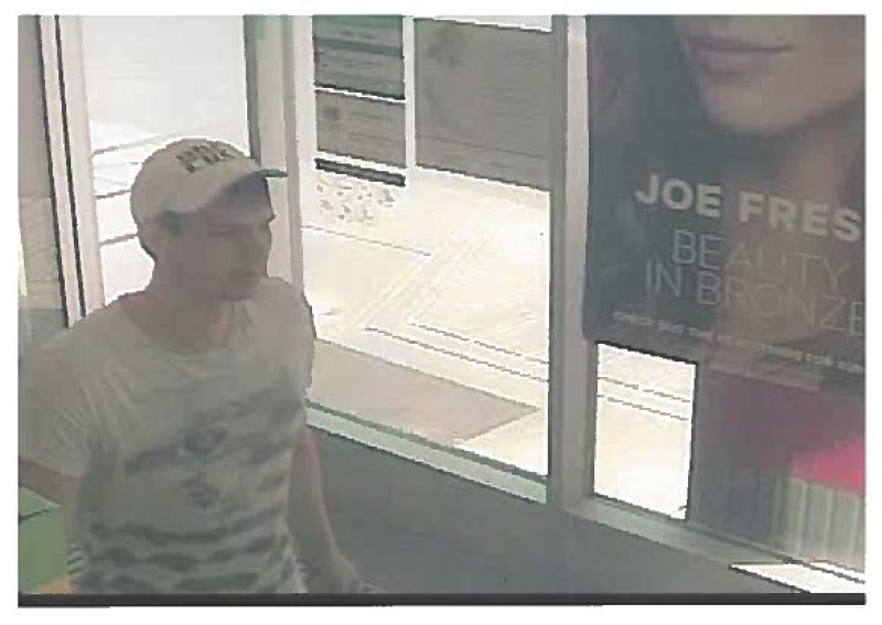 Airdrie RCMP is looking for this man who allegedly used counterfeit bills at the Shoppers Drug Mart on Market Street June 11.