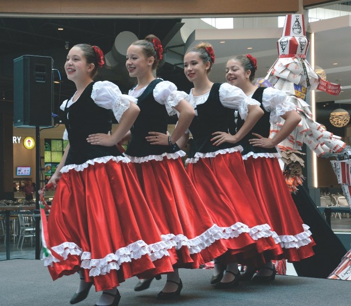 Traditional Italian dancers entertained crowds at the opening celebration for the new food hall in CrossIron Mills mall.