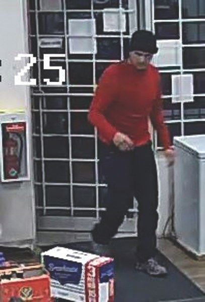 Airdrie RCMP officers are looking for this man captured on video surveillance at a liquor store Sept. 26 after allegedly committing an armed robbery.