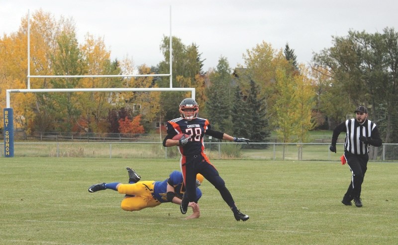 Andrew Hawkes, one of the Grade 12 students on the W.H. Croxford Cavaliers football team, avoided a tackle by a Bert Church Chargers defender during the Cavaliers&#8217;