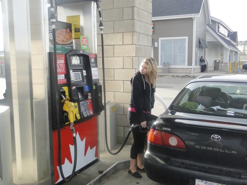 Nicole Bourgeois filled her tank with gas at Petro-Canada Nov. 1. Albertans will see an increase at the pump when the NDP government&#8217;s carbon tax takes effect Jan. 1.