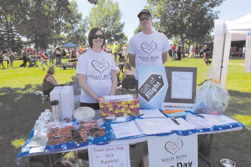 Volunteers manned the Wildrose Humane Society (WHS) booth at its Dog Day Afternoon fundraiser at Nose Creek Park in 2014. The WHS will open a shelter in Didsbury in 2017.