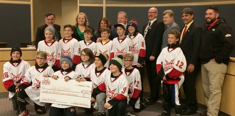 Members of the Airdrie Minor Hockey Association presented Airdrie City council with a $71,431 cheque during the Dec. 5 meeting as part of the association&#8217;s contribution 