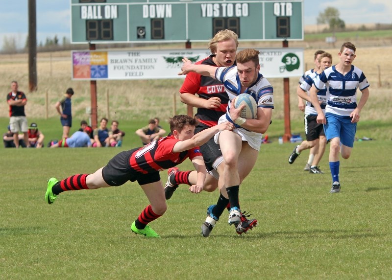 Logan Boomer breaks a pair of tackles during the Bert Church Chargers round robin win over the Chestermere Cowboys in the Rocky View Sports Association Rugby Sevens