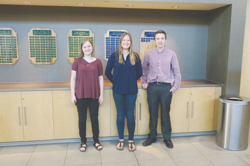 (From left) Faith Harper, Julia Price and Devyn Young each achieved 100 per cent on a Provincial Diploma Exam in January and were recognized at the May 3 Rocky View Schools