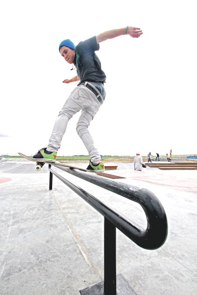 Sixteen-year-old Josh Healey, a team Sully Boardsports skateboarder, rides a rail at the new skatepark in Chinook Winds Park, June 1. The park is finished and open to the