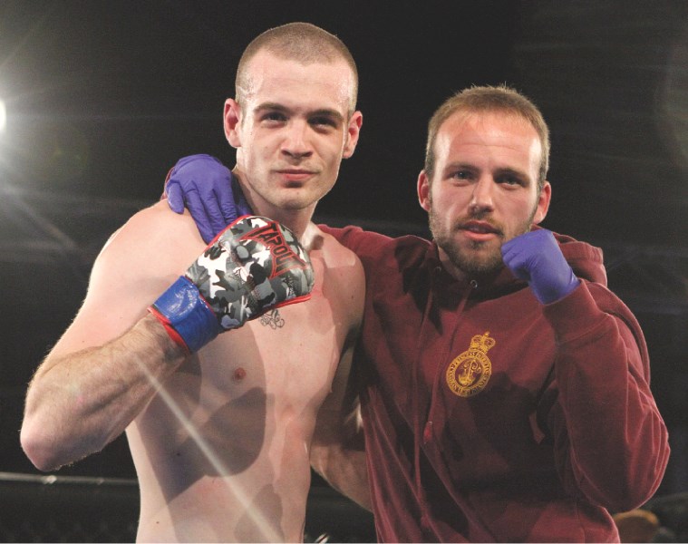 Airdrie fighter Adam Lacasse (left) and teammate Gareth Jones pose for a photo after the unanimous judges decision in Lacasse&#8217; favour during School of Hard Knocks 7,