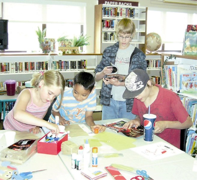 (Left-to-right) Angie Rose, Sean Tandoc and brothers Justin and Blake Bice enjoy hanging out at the Irricana library taking part in the Summer Reading program.