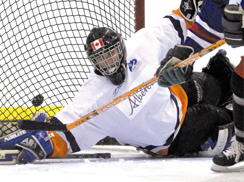 MLA Rob Anderson tries to get in front of a shot by former NHLer Sheldon Kennedy in a shootout during the Wild Rose Hockey Challenge, July 11 at the Ron Ebbesen Arena in