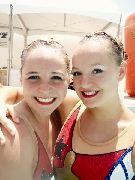 Braley Traub, (left), smiles after competing with teammate Moira McAvoy from their local club, the Calgary Aquabelles.