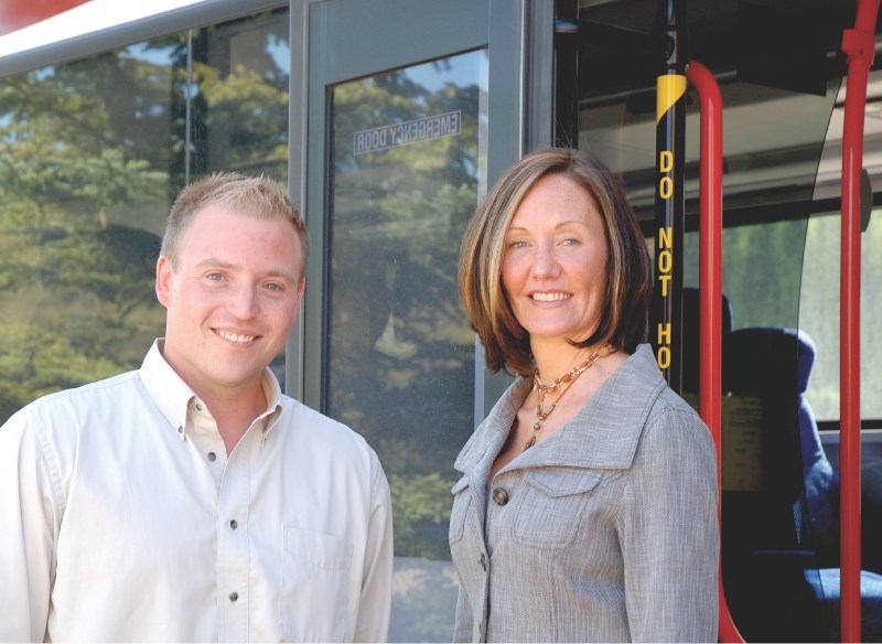 Cochrane Mayor Truper McBride and Calgary Regional Partnership Executive Director Colleen Shepherd pose with the double deck bus that the Town is considering for future