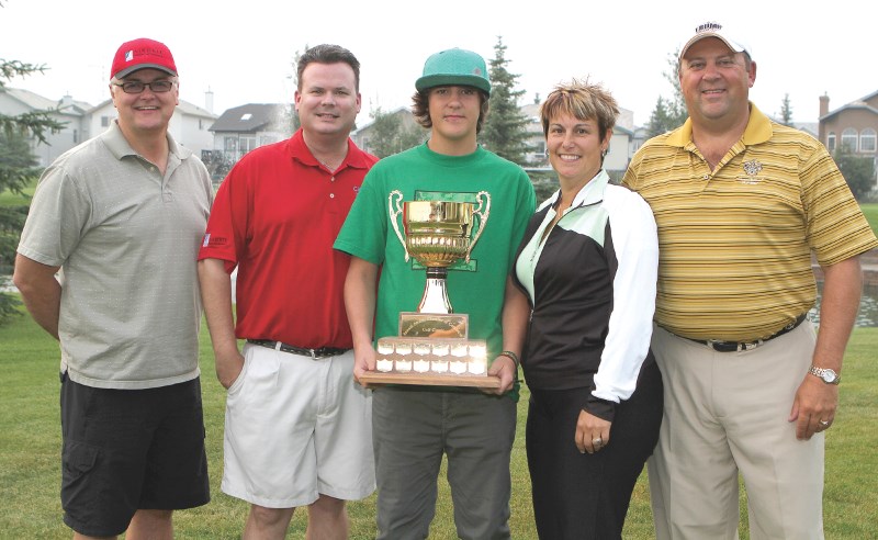 The 2010 Airdrie Chamber of Commerce golf tournament winners Alan Tennant, Matt Carre, Dallas Morrison, Jan Morrison and Bruce Morrison pose with the trophy after the event