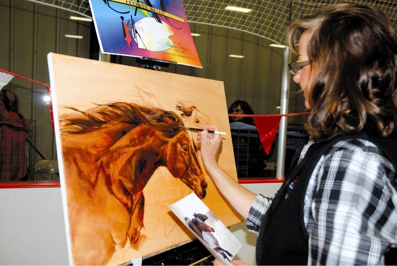 Cochrane Art Club member Shannon Luyendyk demonstrates painting techniques at the 42nd annual Olde Tyme Country Fair, held at Spray Lake Sawmills Recreation Centre, Aug. 29.