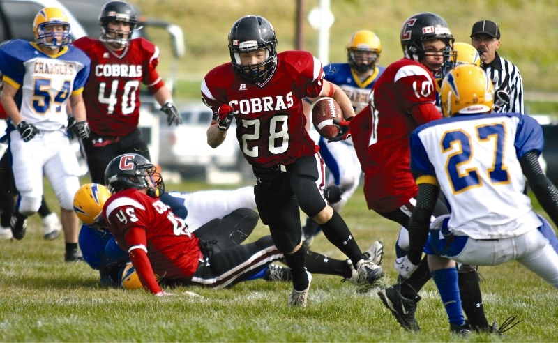Cobras&#8217; running back Kellen Forrest runs for one of his three touchdowns, as Cochrane beat the Bert Church Chargers 43-7 in RVSA football action in Cochrane on Sept. 18.