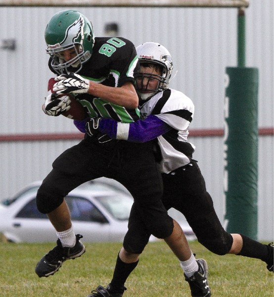 Springbank Phoenix receiver Jordan Perrault-McLean tries to avoid a George McDougall tackle during his team&#8217;s 28-0 shutout win over the Mustangs in RVSA football action 