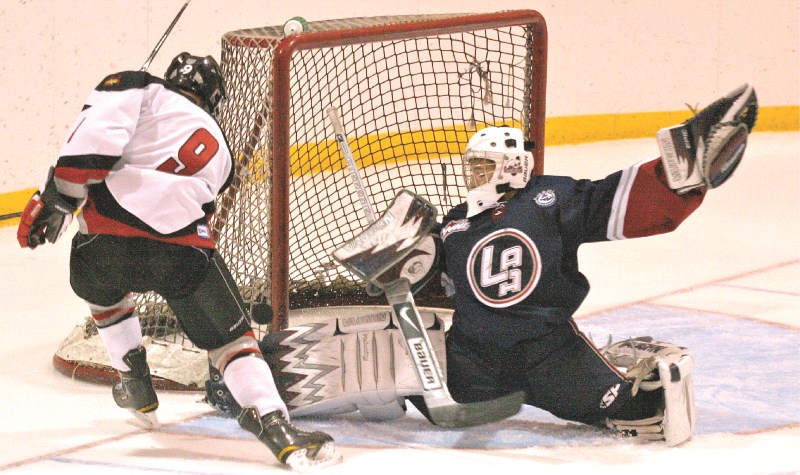 Lethbridge netminder Jonathon Hogue prevents the Xtreme&#8217;s Kyle Pauls from notching his hat trick goal, Sept. 26. The Hawks came from behind to win 4-3.