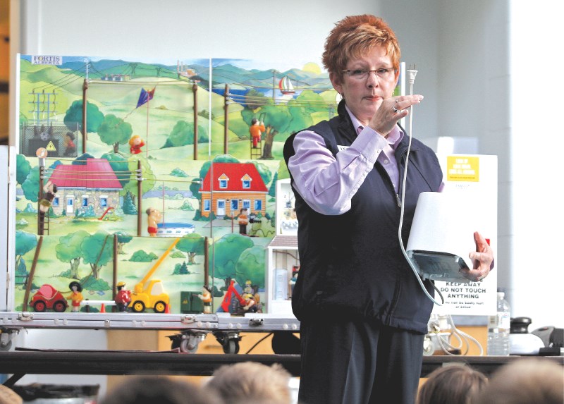 Jeanette Smith, with the FortisAlberta Zap electricity education program, gives a demonstration to Grade 5 students at Our Lady Queen of Peace school Oct. 7.