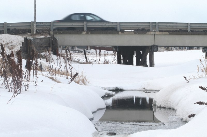 Nose Creek peeks through the snow Jan. 23 in Airdrie&#8217;s northwest community of Stonegate. County council voted to provide more than $15,000 for the Nose Creek Water