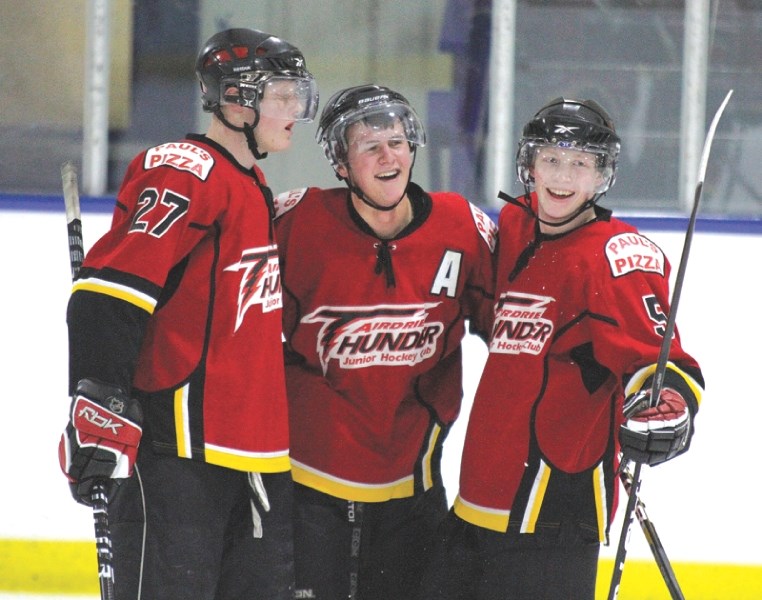 Andrew Bergmann, Travis Wallan and Taylor Crossley celebrate a goal scored in the Airdrie Thunder&#8217;s 5-0 victory over the Strathmore Wheatland Kings, Jan. 28.