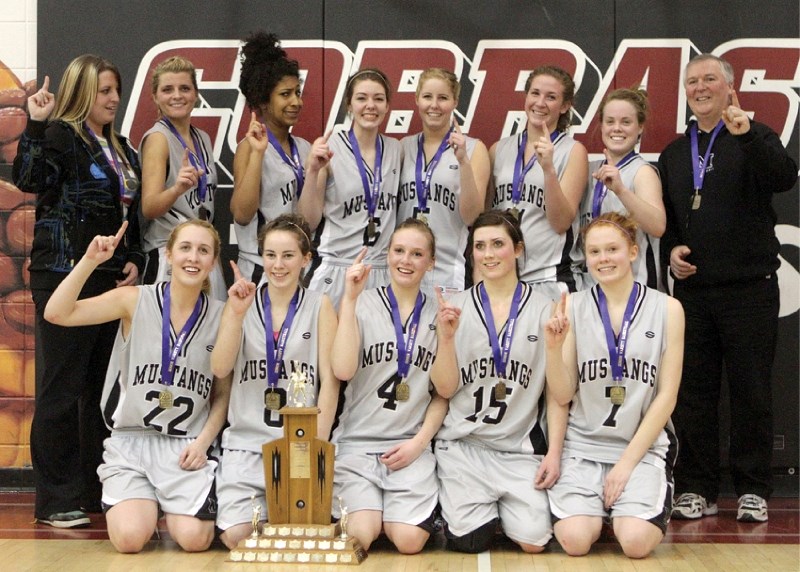 (Top) The George McDougall Lady Mustangs pose for photos with the divisional championship trophy after its 62-58 victory over the Springbank Phoenix March 5 in Cochrane.