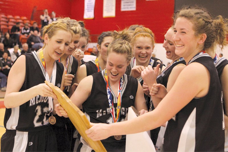 (From left) Natasha Gingerysty, Morgan Schultz and Quinn Diaz lead the George McDougall Lady Mustangs&#8217; celebration following the team&#8217;s bronze medal win over Holy 