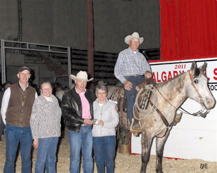 Local ranchers Ron and Irene Hanson (pictured right to left), along with their six-year-old quarterhorse mare Queen, receive a buckle for topping the ranch horse category at