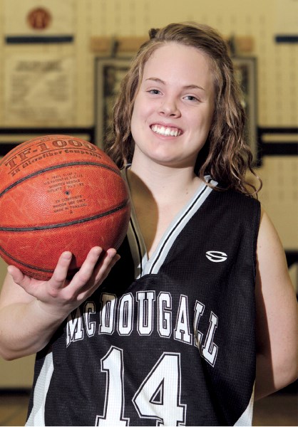Morgan Schultz, seen posing for a photo at the George McDougall gymnasium, April 2, will become a member of the Queens women&#8217;s basketball team at Red Deer College this
