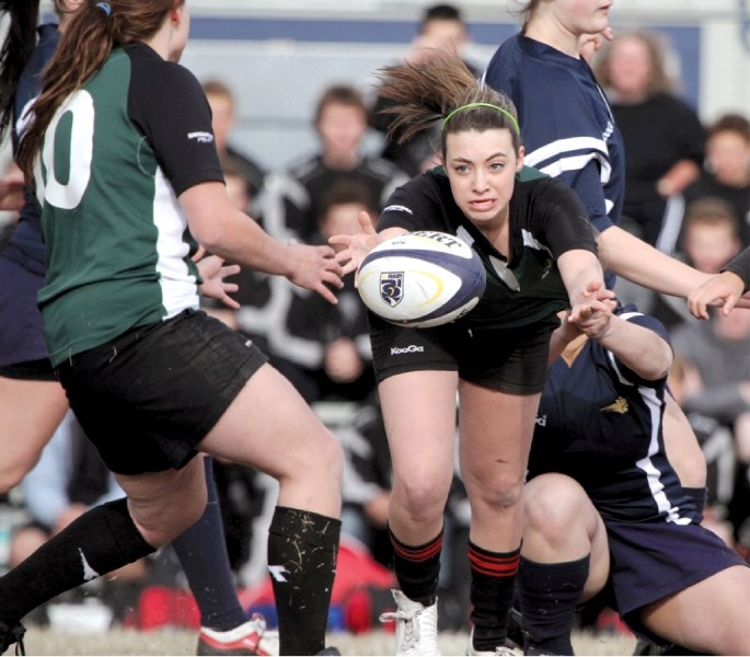 Holy Trinity&#8217;s Angelica Nori passes to a teammate during their matchup against Bow Valley High School, May 6 in Cochrane. Holy Trinity scored 11 tries en route to a