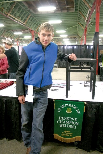 Aiden Jamieson, 15, models the award winning leather jacket and end table he made for 4-H on Parade, the organization&#8217;s year-end competition, which took place at the