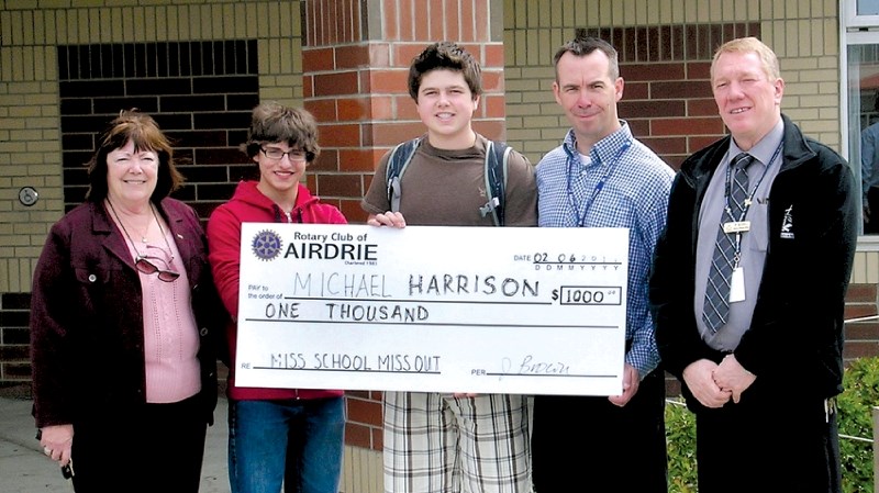 From left to right: Jacquie Brown, Airdrie Rotary; Benjamin Niles, winner; Michael Harrison, winner; John MacDonald, St. Martin de Porres principal and Peter Schill,