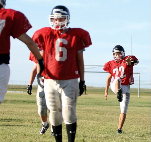 Chestermere player Joel Warbeck runs through a warmup drill during Cowboys practice at the school, Sept. 1. The team, looking to improve from two winless seasons, will open