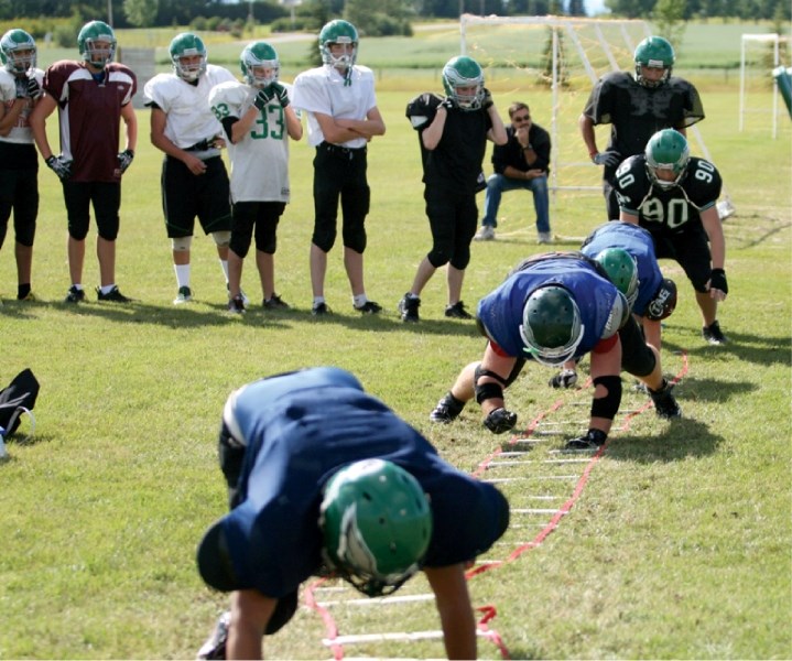 Springbank Phoenix players run through a drill during practice at the school, Sept. 1. The team opens the season on Sept. 9 against Chestermere.