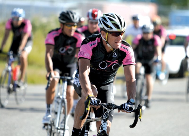 Seven-time Tour de France champion and cancer survivor Lance Armstrong leads a pack of riders from the Wild Wild West Event Centre near Springbank during the Canadian Breast