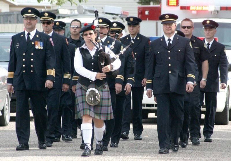 EMS and Rocky View Fire Services firefighters march down the streets of Irricana to commemorate 9/11.