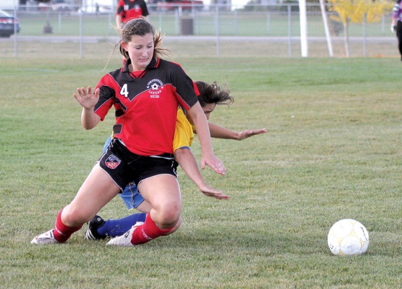 Chestermere Laker Amy Krusina, who tallied two goals in her team&#8217;s 5-1 victory, battles a Bert Church Chargers opponent for a loose ball, Sept. 22 at Monklands Soccer