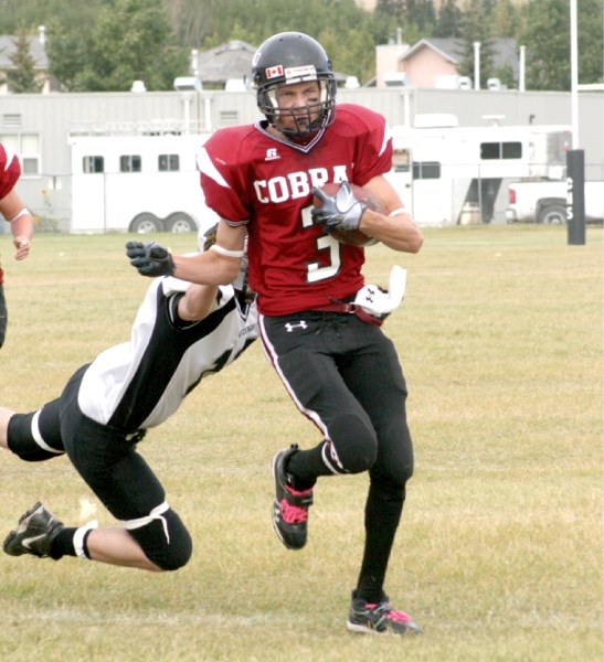 Cochrane Cobra Zane Churchill dodges a tackle and runs for a touchdown. The Cobras defeated the George McDougall Mustangs 52-14. Churchill had one other touchdown in the game 