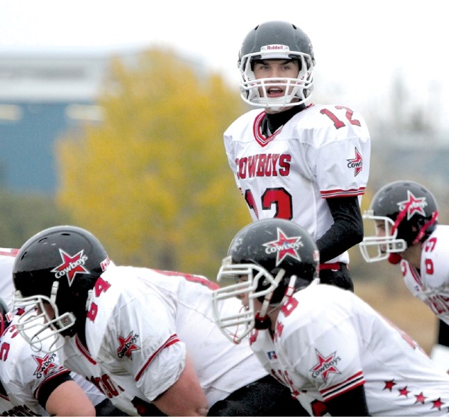 Cowboys&#8217; quarterback Brad Taubert calls a play at the line of scrimmage during Chestermere&#8217;s 19-19 tie with the George McDougall Mustangs at Genesis Place field