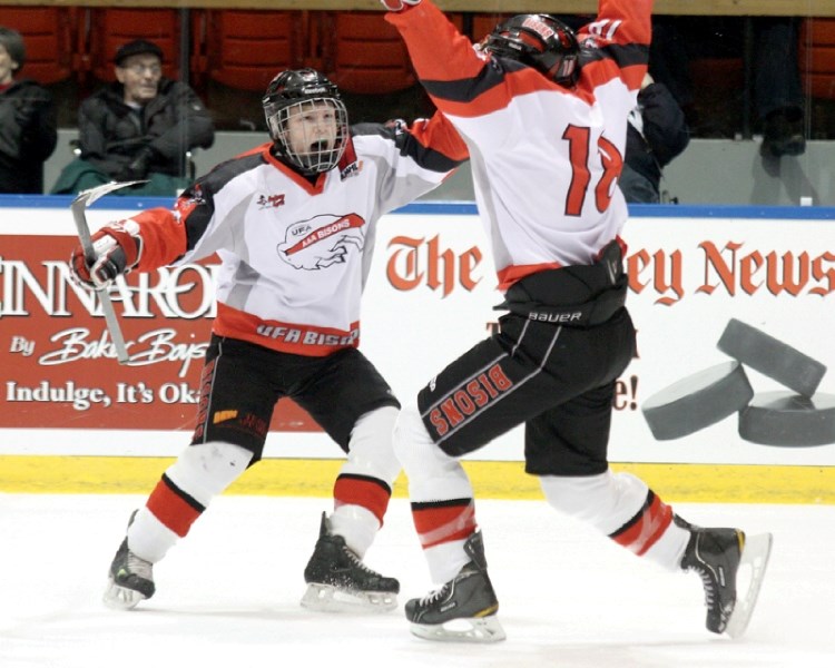 The UFA&#8217;s Lenny Hackman and Conner Bleackley celebrate a goal, Dec. 27 at the Mac&#8217;s Midget AAA World Invitational Tournament. The Bisons made it to the gold medal 