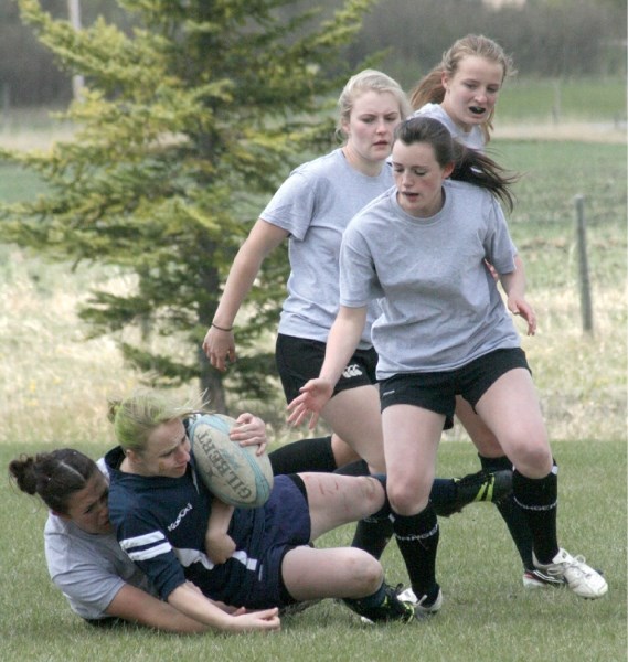 Karlee Squires, Lisa Wattam and Kristina Moore watch as teammate Shannon Fitzpatrick makes a tackle at the team&#8217;s home tournament, May 26. Phoenix won the game.
