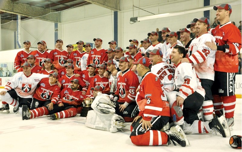 The 40 men who participated in the Hockey Marathon in Chestermere celebrate their achievement at the recreation centre, May 16.