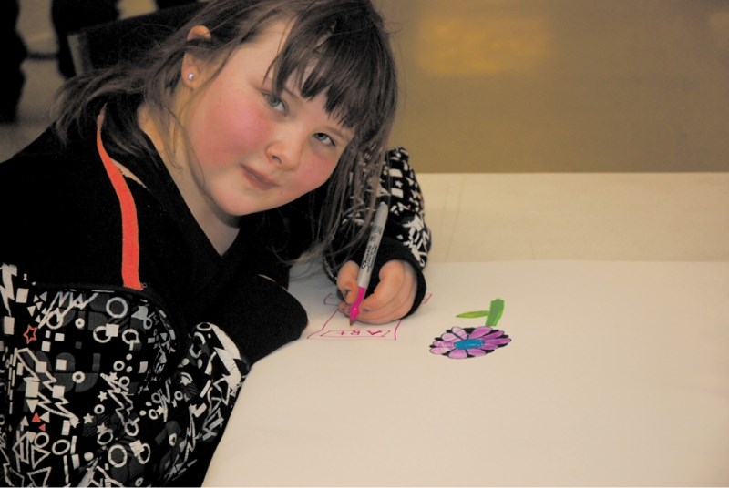 future of irricana &#8211; Nine-year-old Suzanne Shields shows council her artistic skills and what she thinks the town needs on Jan. 17 at Idea Fest. The young artist said
