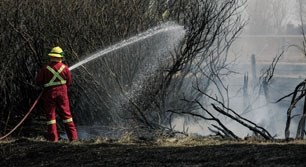The Airdrie Fire Department battles a grass fire at an acreage just north of Airdrie May 2. The fire was brought under control around 3 p.m. and no injuries or damage to