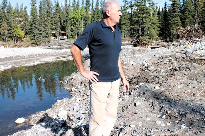 On Sept. 26, Marek Grzesiak, owner of the Riverside Chateau, stands behind his residence and business, located along the Elbow River in Bragg Creek. Grzesiak said he plans to 