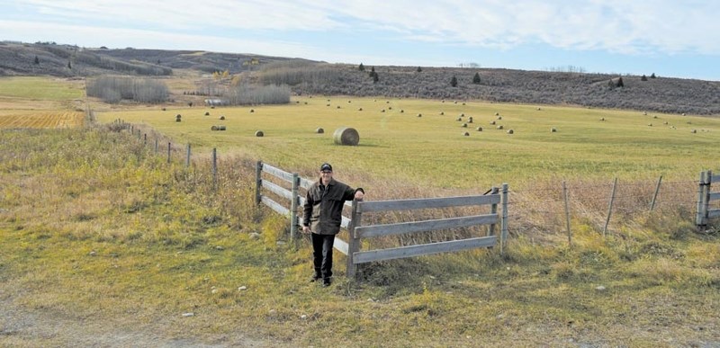 Rocky View County resident and landowner Terry Raymond stands at the intersection of two undeveloped road allowances that run along his property. Raymond said hunters