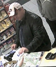 Image of a male suspect captured by a surveilance camera at a Canmore business where the suspect attmpted to make purchases with stolen credit cards.