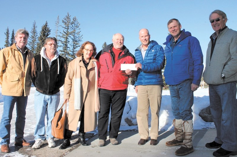 Banff-Cochrane MLA Ron Casey presents a $125,000 check from the Provincial government to Greater Bragg Creek Trails Association President Robert Sadee in Bragg Creek on Jan.