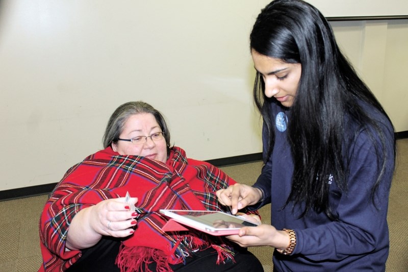 Carmela Hutchinson, left, got some help from Tejal Sisodiya of the Highland Primary Care Network as she signed up for the HPCN&#8217;s Health Challenge event on Feb. 21 at