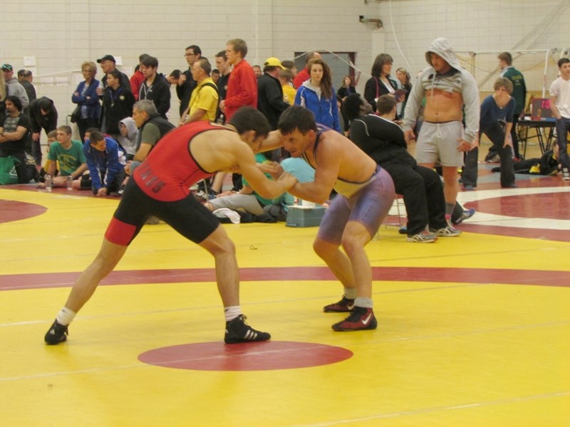 Russell Friend stood on the top of the podium with his son Cash after he won the provincial 70-kg open division wrestling title in Calgary on March 16.